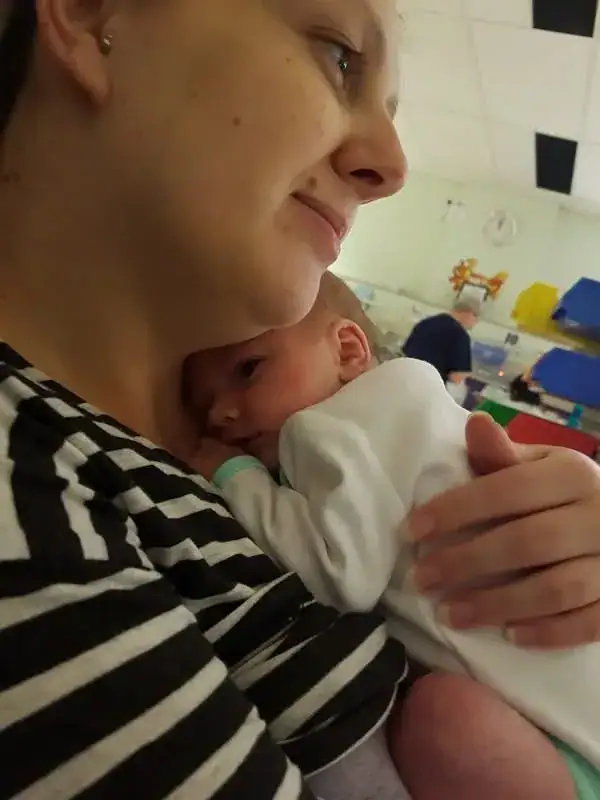 Mel Jessup holding newborn